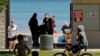 Signs are seen at Clark Street Beach during COVID-19 as people gather in Evanston, Ill., June 23, 2020.